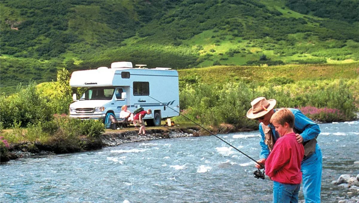 Family fishing by an RV in Alaska
